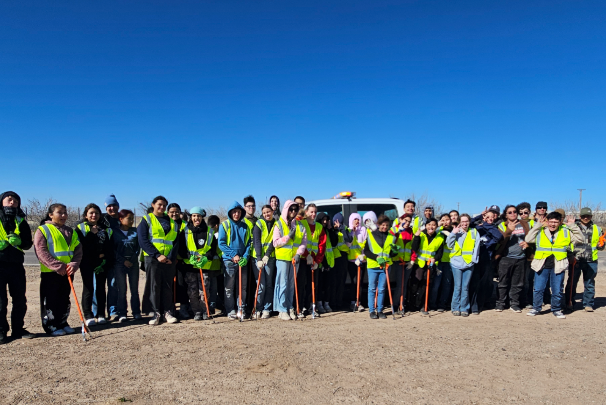 Untitled design (22) Young people collecting trash in a park.